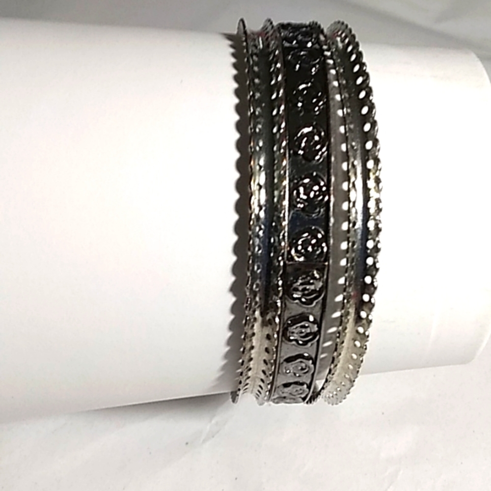 3 faux silver metal bracelets.